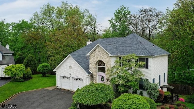 19 Trails End Ct, Westfield Town, NJ 07090 - view of front of house featuring driveway, a front lawn, stone siding, a chimney, and roof with shingles