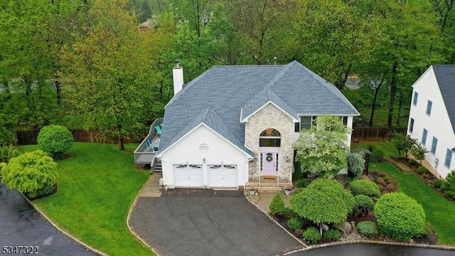 19 Trails End Ct, Westfield Town, NJ 07090 - view of front facade featuring a garage, driveway, a chimney, and stone siding