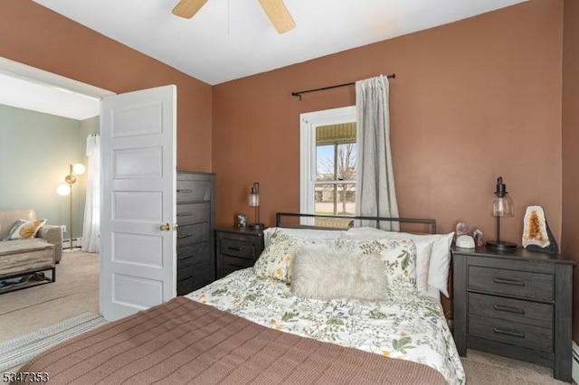 carpeted bedroom featuring a baseboard radiator, vaulted ceiling, and ceiling fan