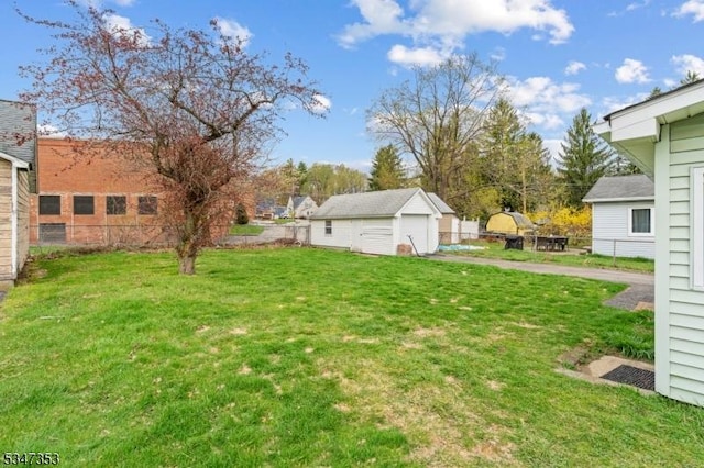 view of yard with fence and a detached garage
