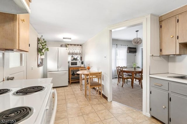 kitchen with light countertops, a wall unit AC, gray cabinetry, and white appliances