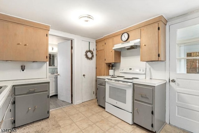 kitchen featuring gray cabinets, light floors, light countertops, under cabinet range hood, and white electric stove