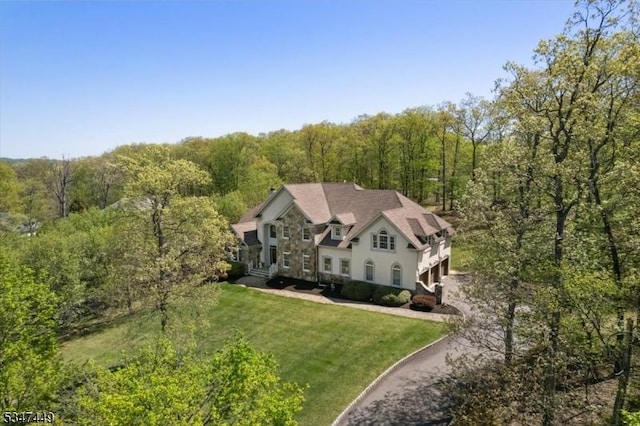 drone / aerial view featuring a wooded view