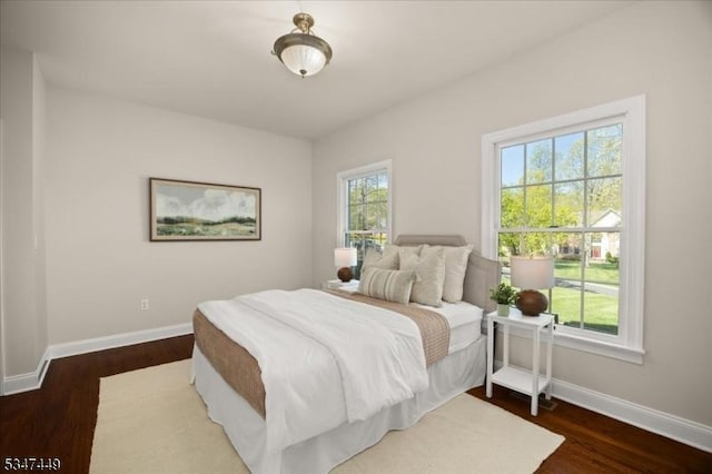 bedroom featuring baseboards and wood finished floors