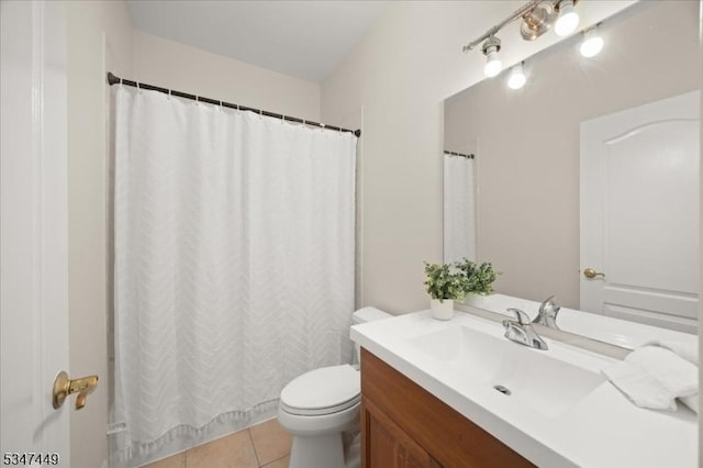 bathroom featuring toilet, a shower with shower curtain, tile patterned flooring, and vanity