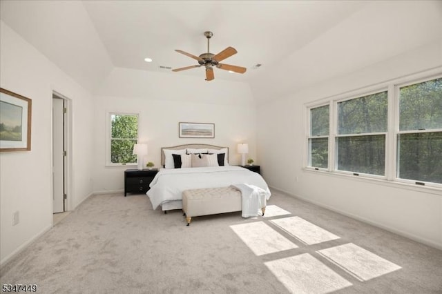 bedroom featuring vaulted ceiling, multiple windows, and light carpet