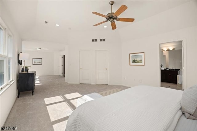 bedroom featuring light colored carpet, recessed lighting, visible vents, and vaulted ceiling
