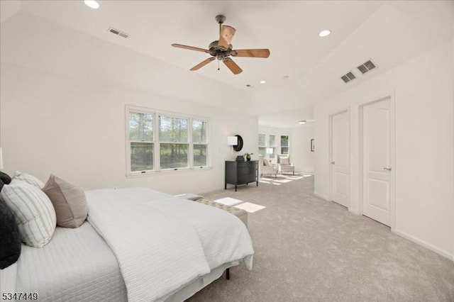 bedroom with multiple windows, light carpet, and recessed lighting