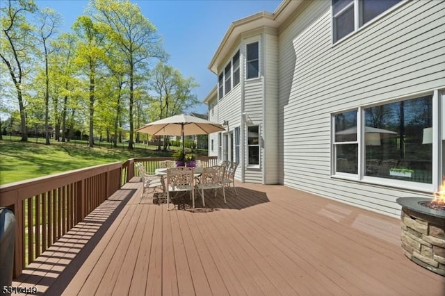 wooden terrace with outdoor dining space