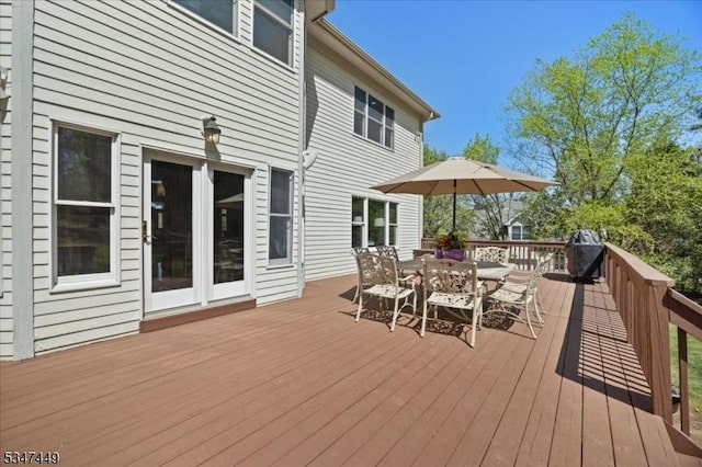 wooden terrace with outdoor dining area