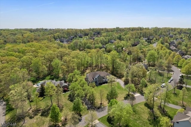 bird's eye view featuring a wooded view