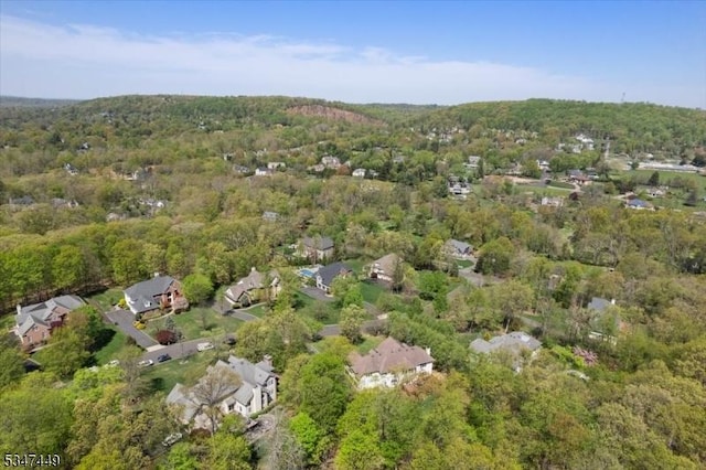 bird's eye view featuring a residential view and a wooded view