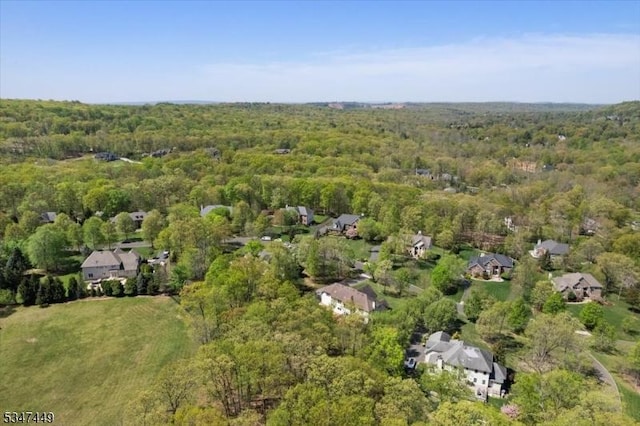 birds eye view of property with a residential view and a wooded view