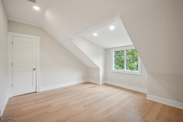 bonus room with light wood-type flooring, recessed lighting, vaulted ceiling, and baseboards