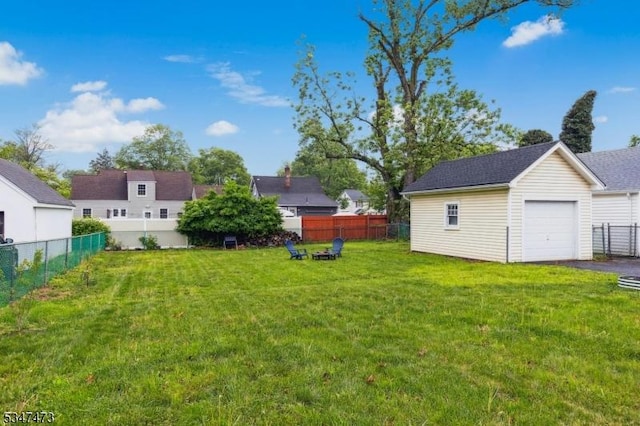 577-9 Greenbrook Rd, North Plainfield Boro, NJ 07063 - view of yard with a garage, an outbuilding, driveway, and an outdoor fire pit