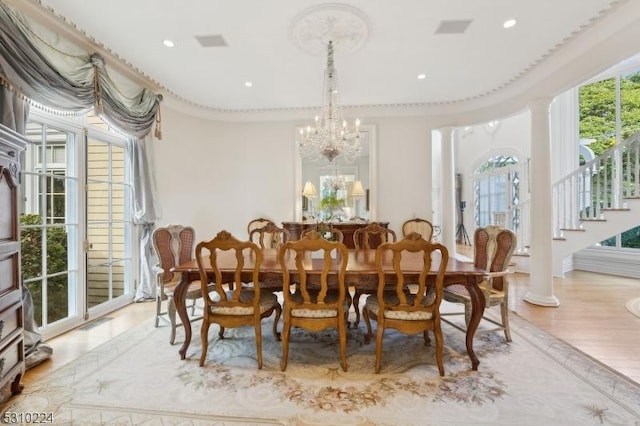 dining room with an inviting chandelier, visible vents, recessed lighting, stairway, and wood finished floors