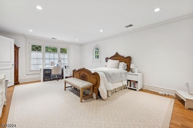 bedroom with ornamental molding, visible vents, light wood-style flooring, and recessed lighting