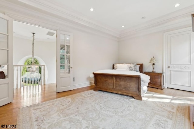 bedroom featuring wood finished floors, ornamental molding, visible vents, and recessed lighting