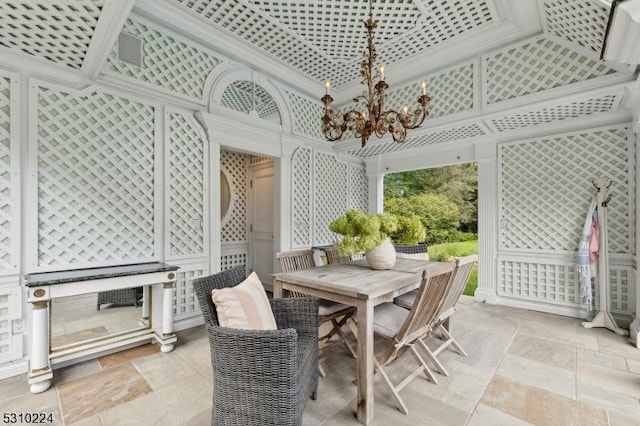 sunroom / solarium with outdoor dining space and a chandelier