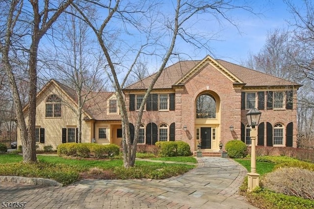 georgian-style home with brick siding