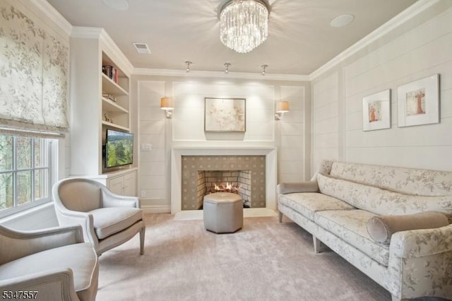 carpeted living room featuring a chandelier, a tiled fireplace, visible vents, and ornamental molding
