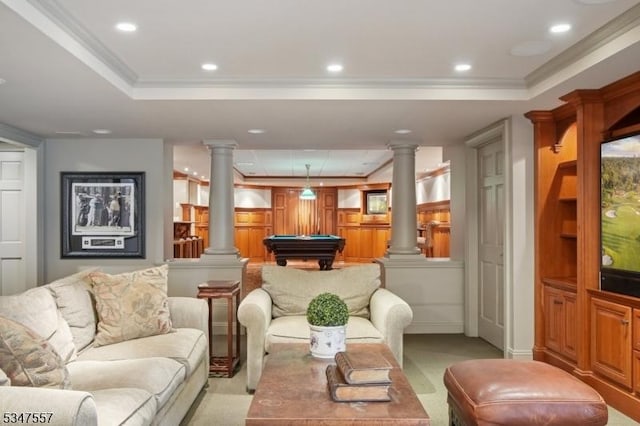 living area with crown molding, pool table, ornate columns, and a raised ceiling