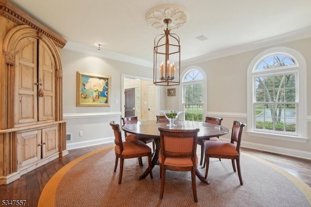 dining space featuring dark wood finished floors, baseboards, and ornamental molding