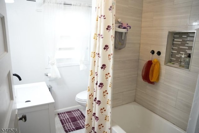bathroom featuring shower / bath combo, toilet, and vanity
