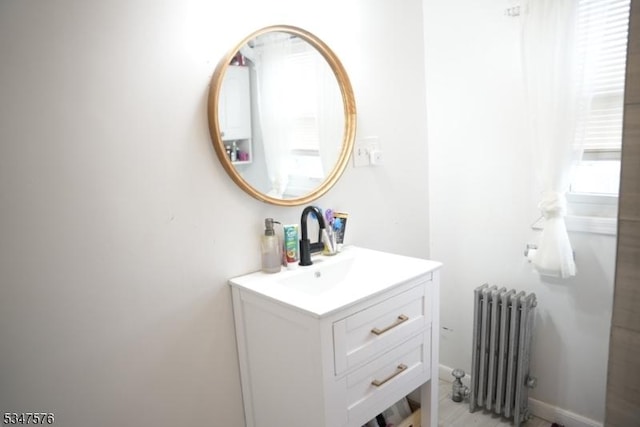 bathroom with radiator and vanity