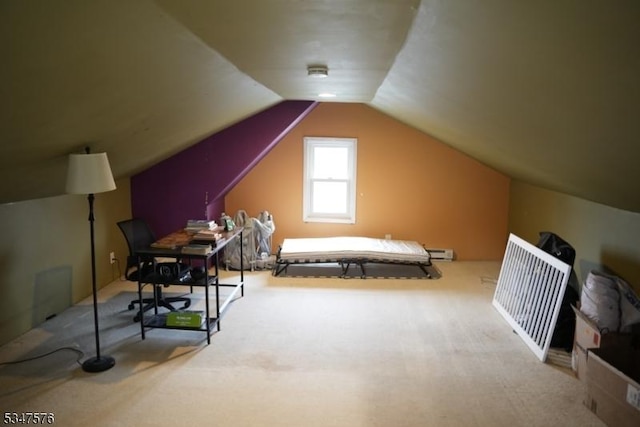 bedroom with carpet floors and lofted ceiling