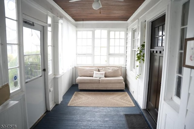 sunroom with wooden ceiling, wood finished floors, and ornamental molding