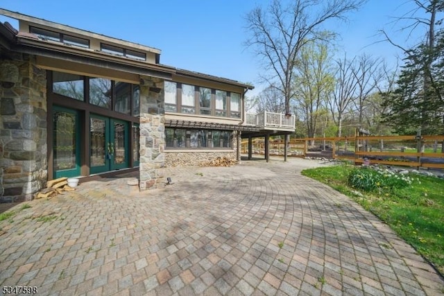 69 Mount Pleasant Rd, Knowlton Twp, NJ 07832 - rear view of house with a wooden deck, fence, and stone siding