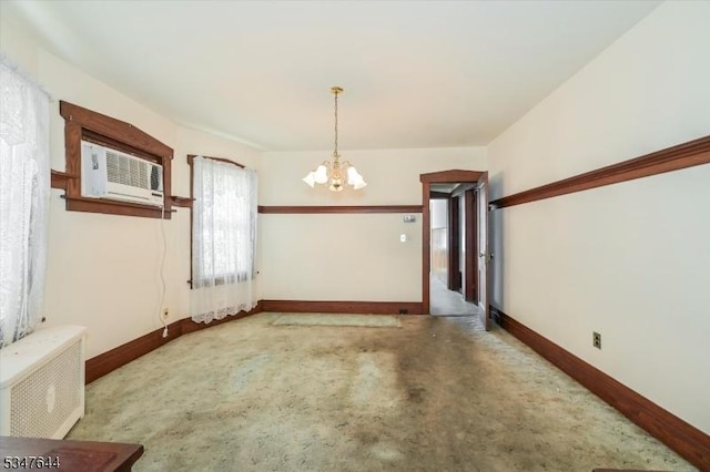 unfurnished dining area featuring a chandelier, baseboards, and carpet flooring