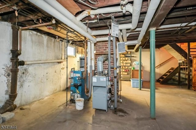 below grade area featuring stairway and a heating unit