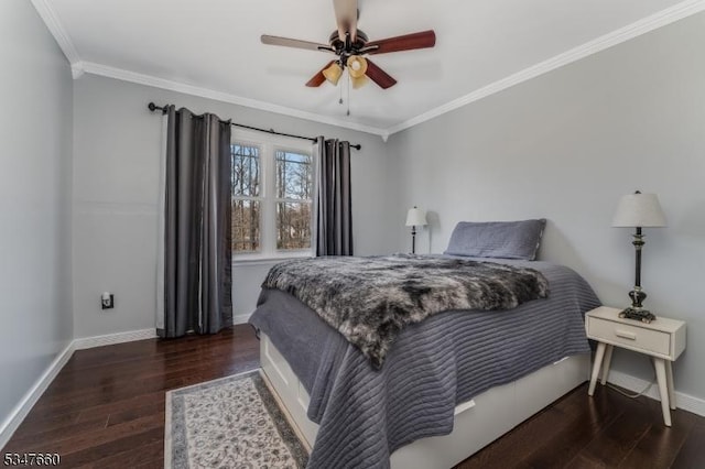 bedroom with baseboards, wood finished floors, and crown molding