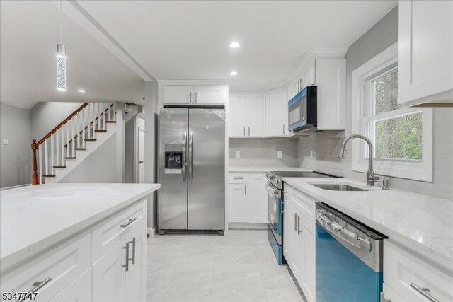 7 Mondamin Rd, Vernon Twp, NJ 07422 - kitchen with appliances with stainless steel finishes, decorative backsplash, white cabinetry, light stone countertops, and recessed lighting