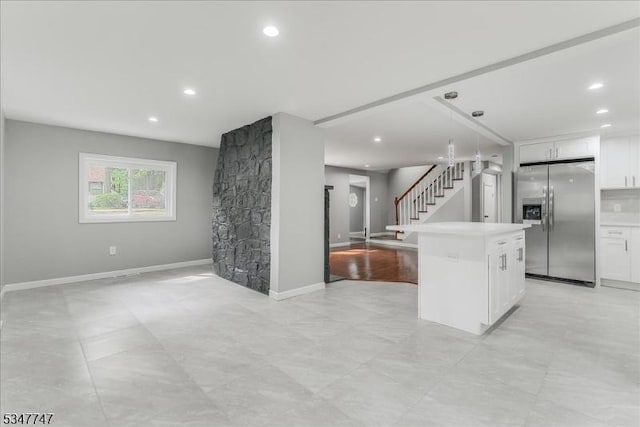 7 Mondamin Rd, Vernon Twp, NJ 07422 - kitchen featuring stainless steel refrigerator with ice dispenser, open floor plan, white cabinetry, light countertops, and recessed lighting