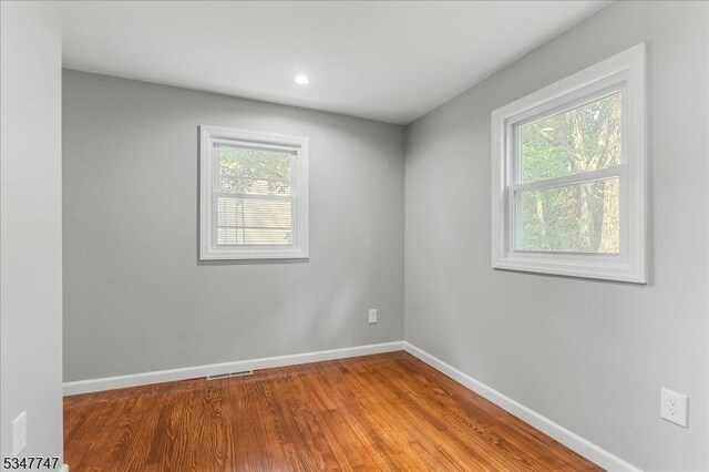 7 Mondamin Rd, Vernon Twp, NJ 07422 - empty room with healthy amount of natural light, wood finished floors, and recessed lighting