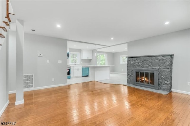 7 Mondamin Rd, Vernon Twp, NJ 07422 - unfurnished living room featuring a fireplace, light wood finished floors, and recessed lighting