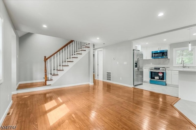 7 Mondamin Rd, Vernon Twp, NJ 07422 - unfurnished living room featuring light wood-style flooring, stairway, and recessed lighting