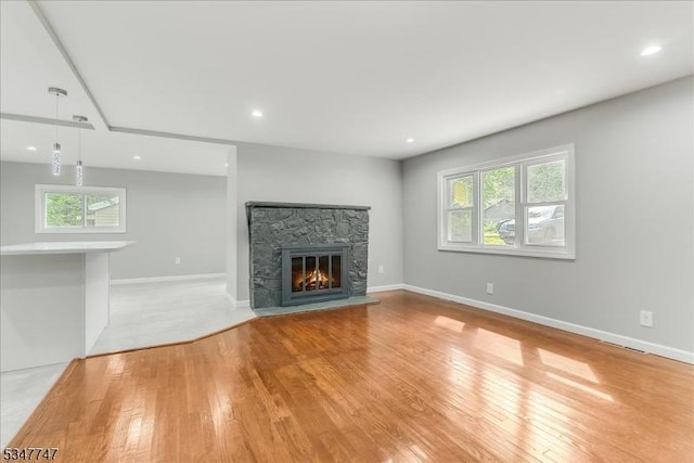 7 Mondamin Rd, Vernon Twp, NJ 07422 - unfurnished living room featuring light wood finished floors, a stone fireplace, and recessed lighting