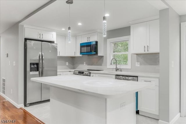7 Mondamin Rd, Vernon Twp, NJ 07422 - kitchen featuring appliances with stainless steel finishes, white cabinets, a kitchen island, pendant lighting, and recessed lighting