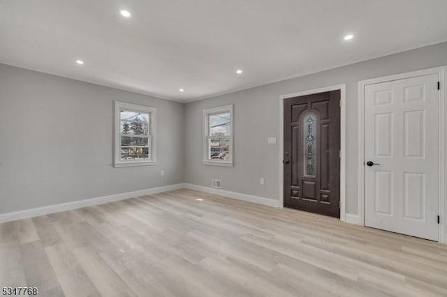 interior space featuring recessed lighting, light wood finished floors, visible vents, and baseboards