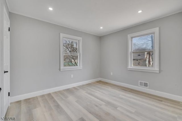 empty room featuring recessed lighting, visible vents, and a healthy amount of sunlight