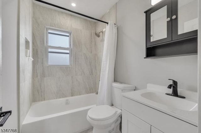 full bath with toilet, shower / bath combo, and vanity