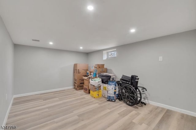 below grade area featuring recessed lighting, visible vents, baseboards, and wood finished floors