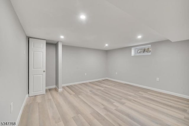basement featuring light wood finished floors, baseboards, and recessed lighting
