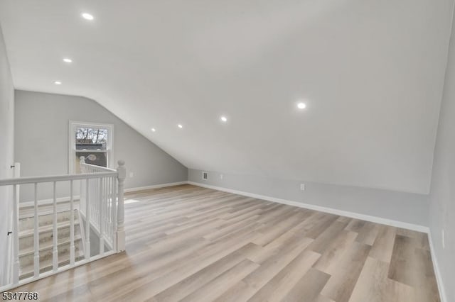 additional living space with baseboards, recessed lighting, light wood-style floors, and lofted ceiling