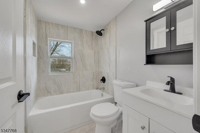 full bathroom featuring toilet, vanity, and bathtub / shower combination