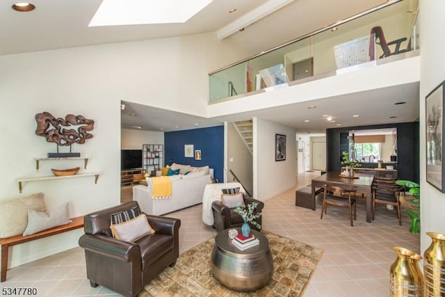204 Barringer Ct, West Orange Twp, NJ 07052 - living room with high vaulted ceiling, a skylight, stairs, and tile patterned flooring